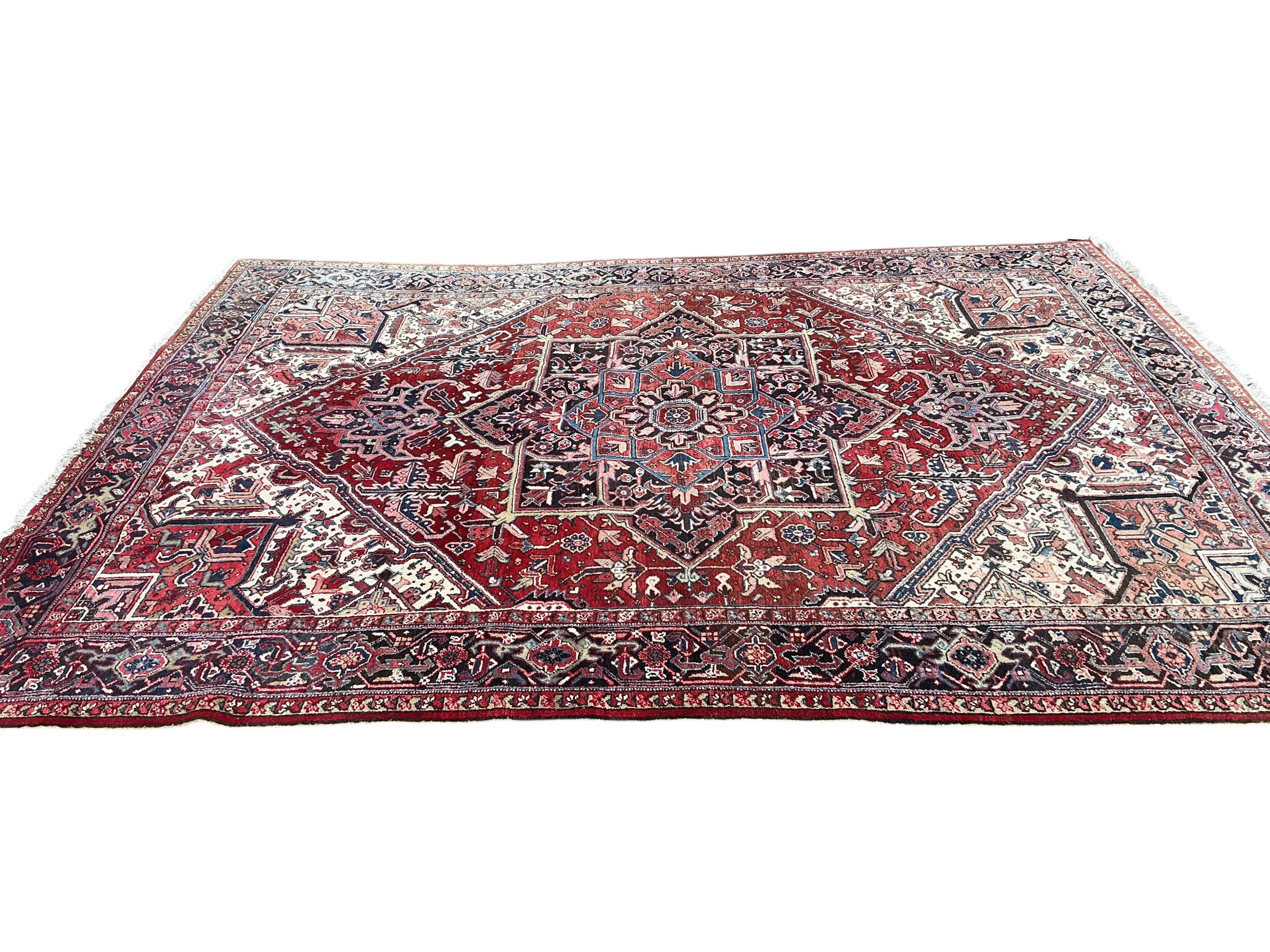 A Heriz red ground carpet, 345 x 265cm